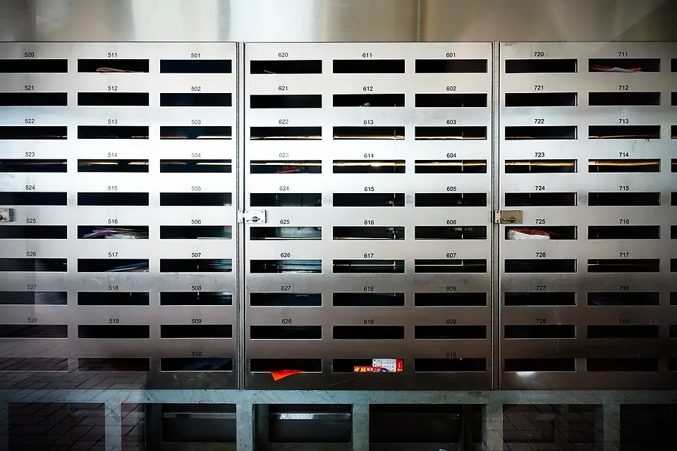 The rear view of a section of apartment mailboxes, Shui Chuen O Estate, Shatin, Hong Kong.
